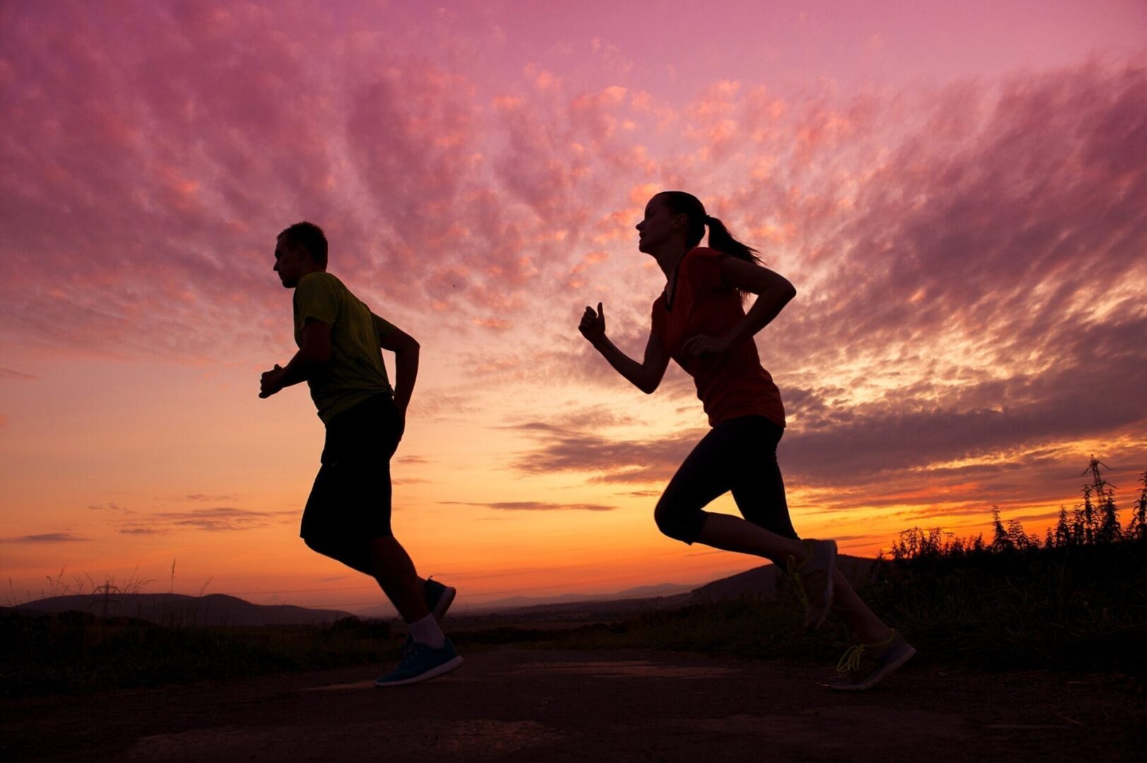 graphicstock-silhouette-of-young-couple-running-in-sunset_HC21q9hWZ-scaled