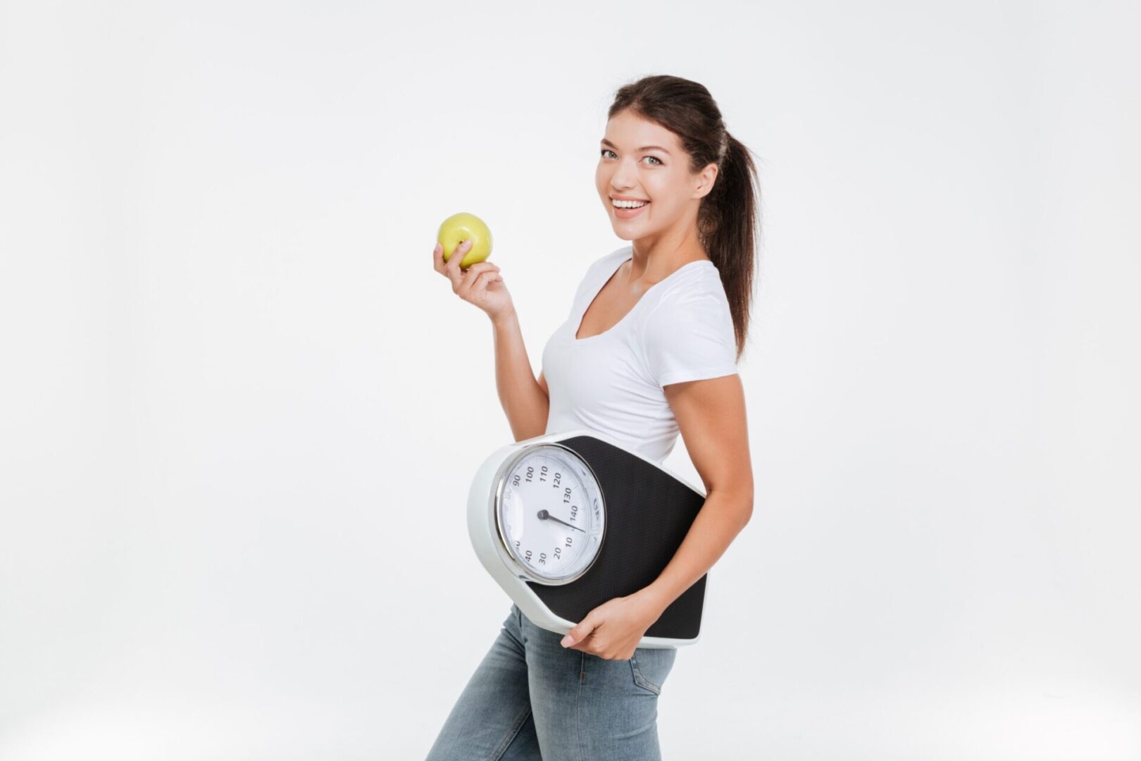 graphicstock-woman-holding-scale-and-apple-for-healthy-lifestyle-and-nutrition-isolated-over-white-background-looking-at-camera_HOxgRXH8ne-scaled